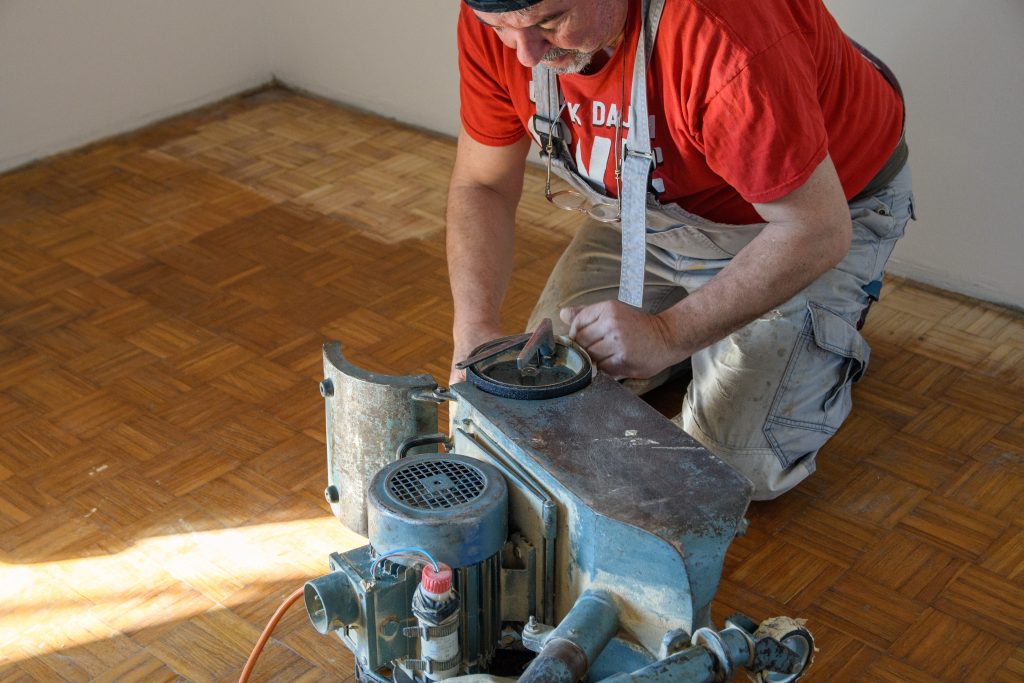 Floor sanding the hardwood floor.