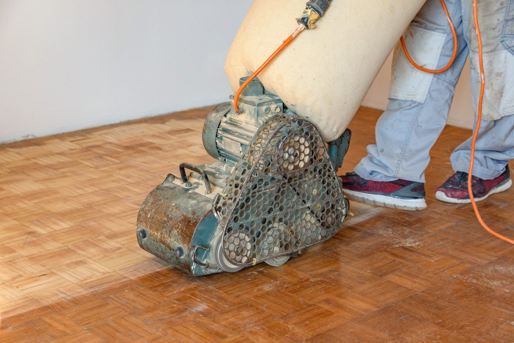 Floor sanders in Auckland, floor sanding the wooden floor.